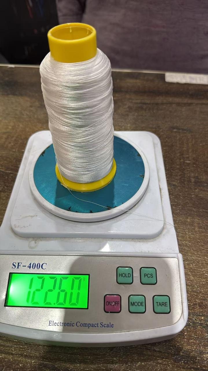 Thread sample being weighed